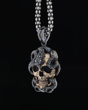 Skull and snake figure necklace